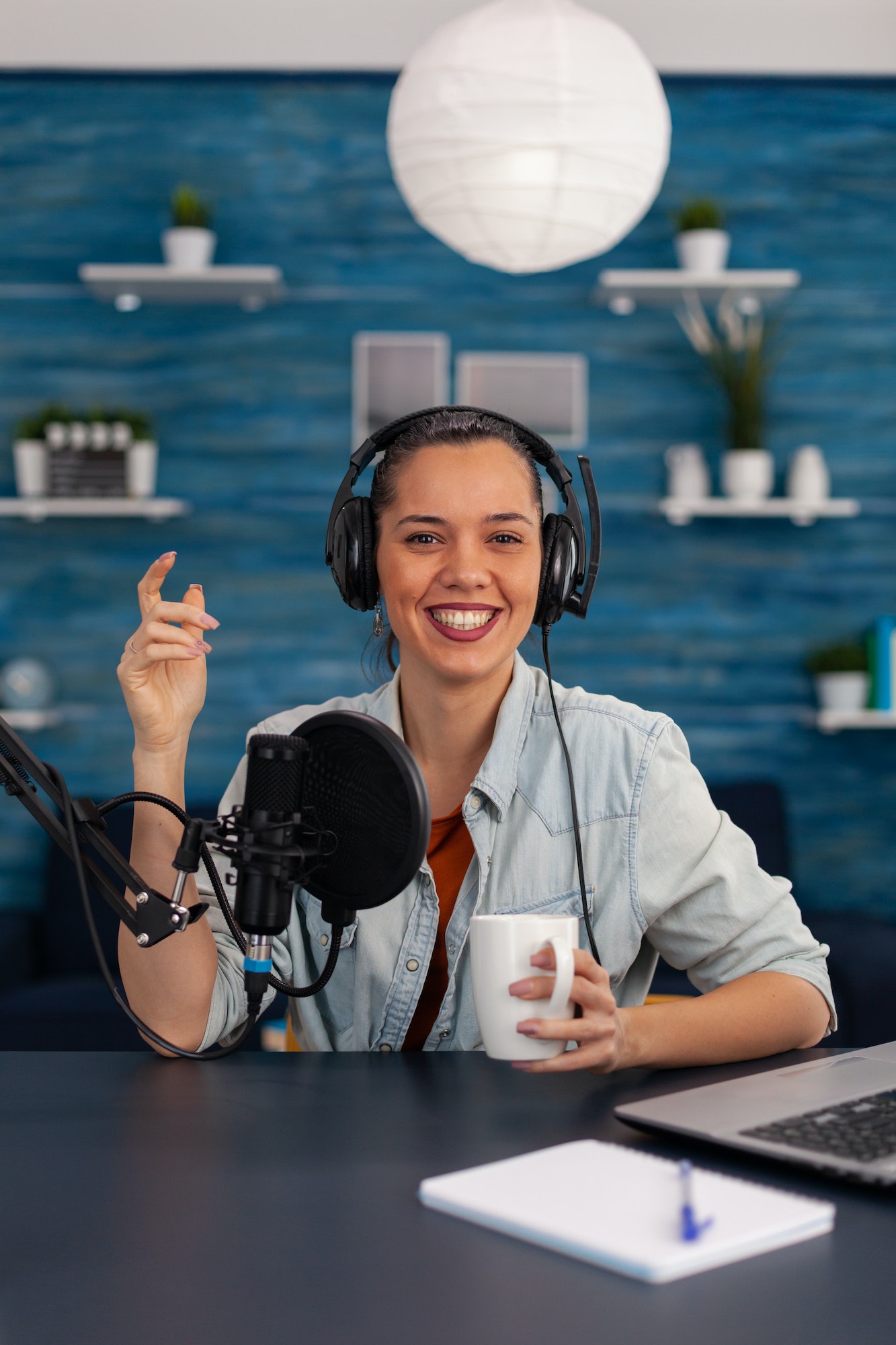 portrait-of-happy-woman-facing-camera-recording-in-home-studio.jpg