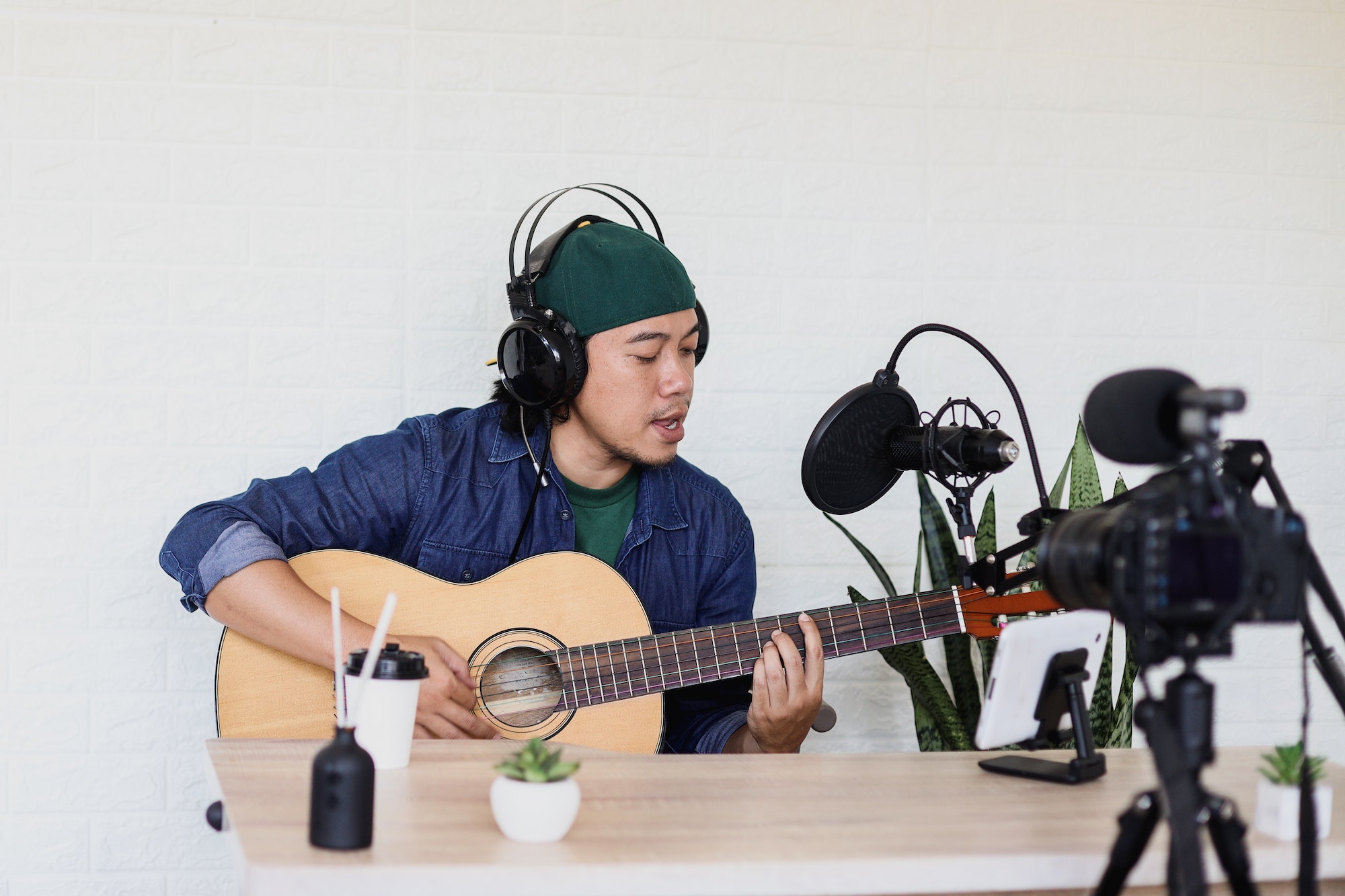 young-man-is-singing-and-play-guitar-on-music-podcast.jpg