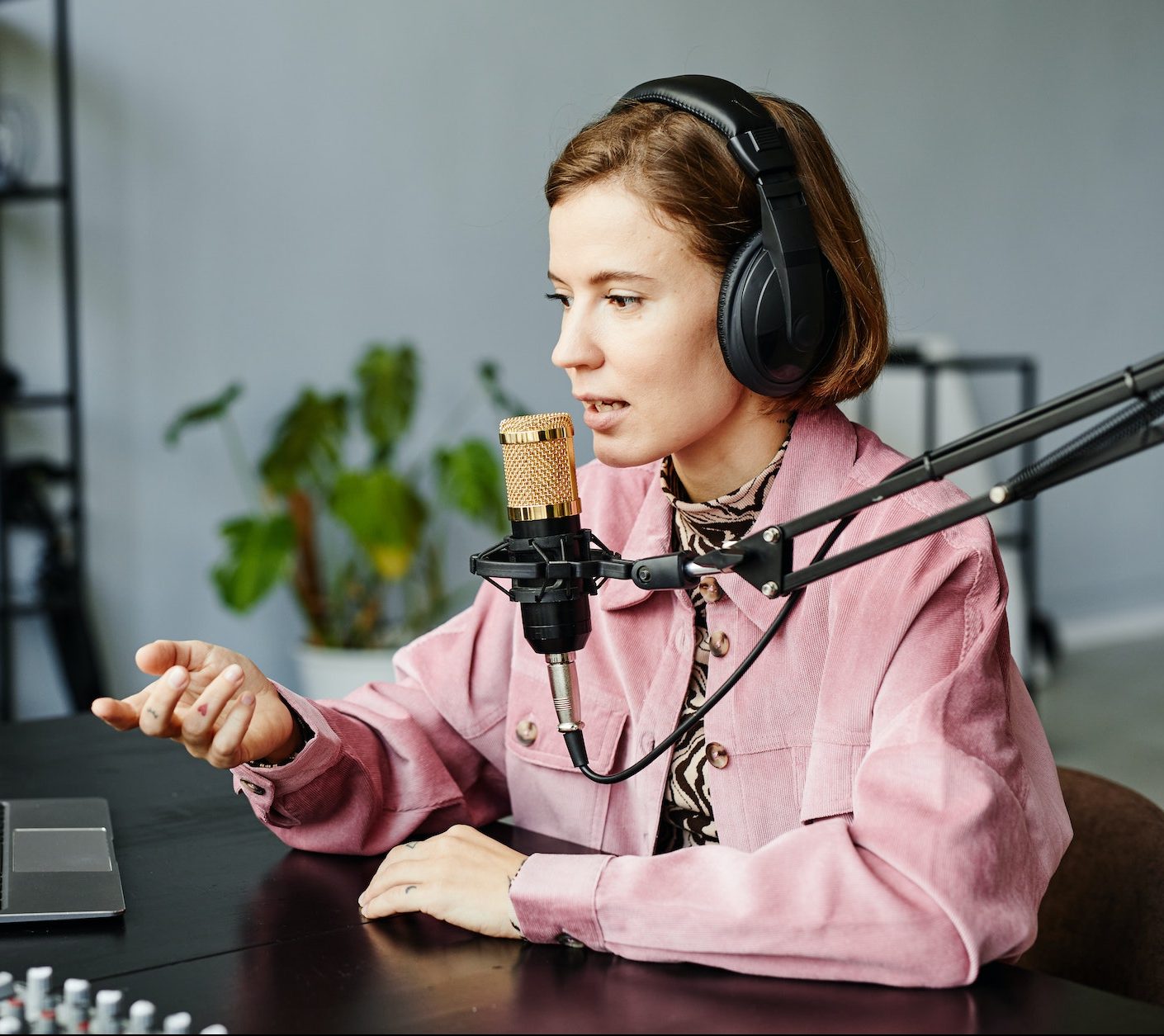 young-woman-recording-podcast-at-home-e1665506644614.jpg